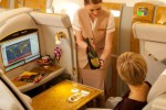 Flight attendant serving champagne on first class