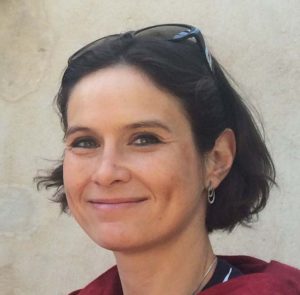 Image of a smiling woman wearing sunglasses