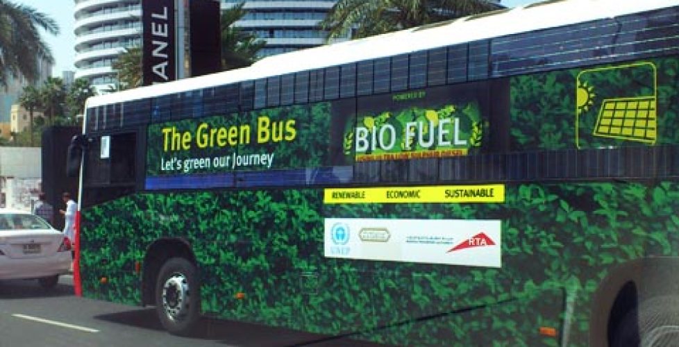 Green bus on the streets of Dubai