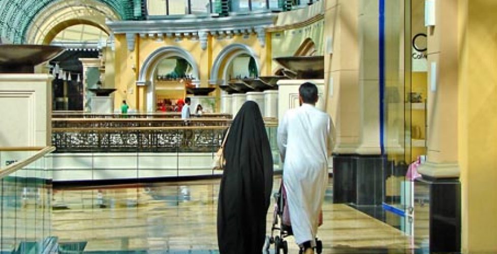 A couple is walking in a shopping mall in Dubai