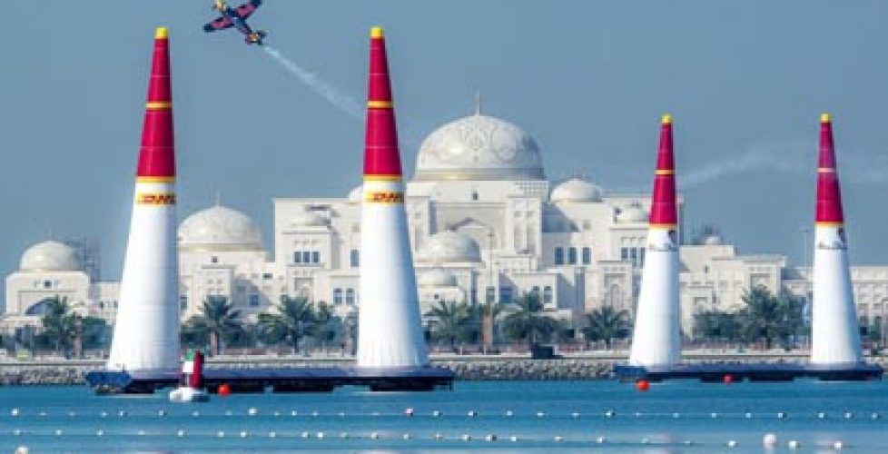 Airplane flies above the water in Abu Dhabi for the Red Bull Air Race