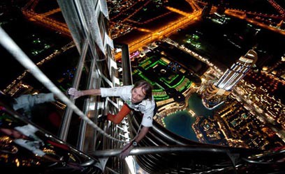 Man climbing skyscraper without any help or gear