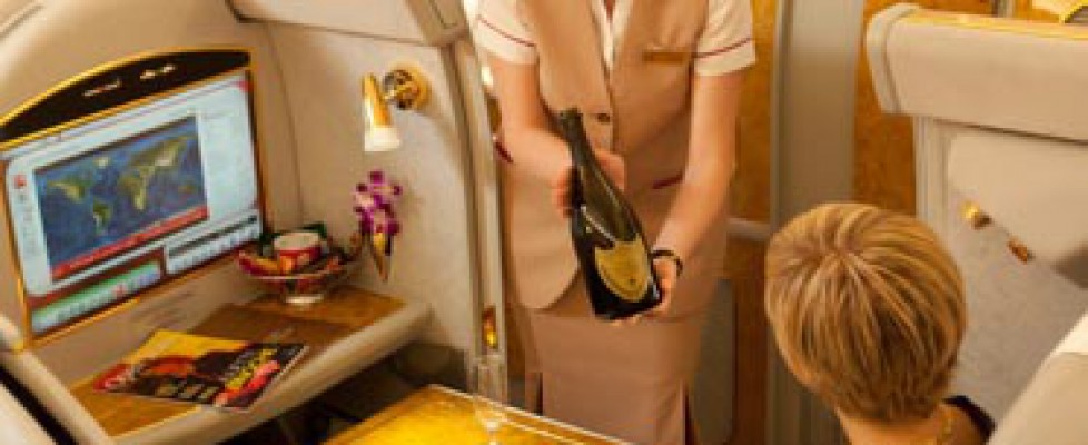 Flight attendant serving champagne on first class