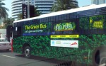 Green bus on the streets of Dubai