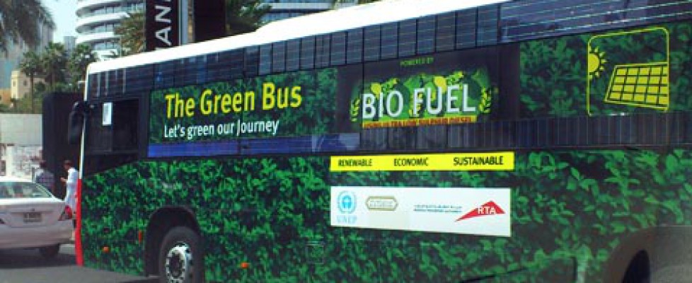 Green bus on the streets of Dubai