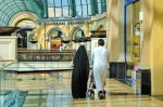 A couple is walking in a shopping mall in Dubai