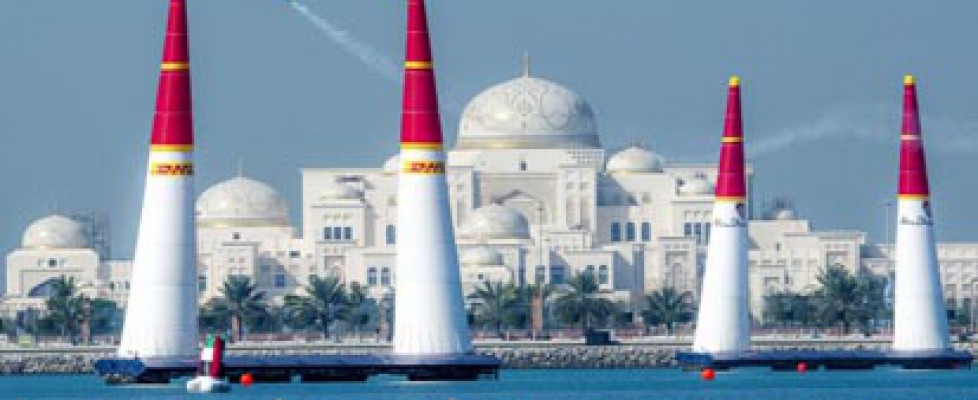 Airplane flies above the water in Abu Dhabi for the Red Bull Air Race