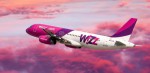 Airplane among the pink and purple clouds