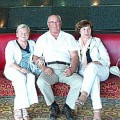 A man and two women are sitting in a hotel lobby